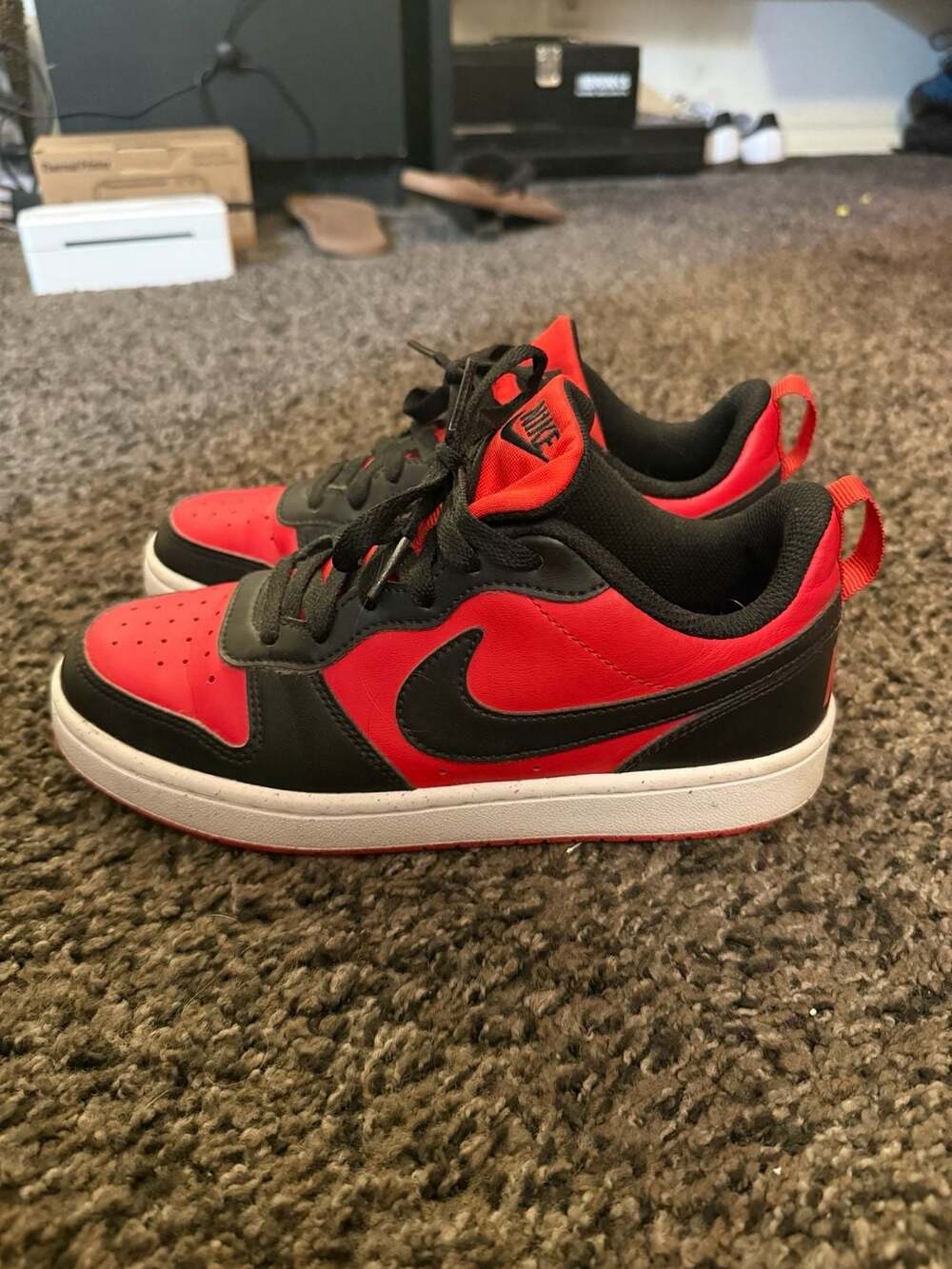 red and black Nike Court Borough